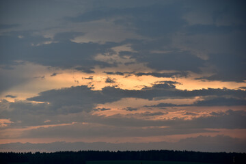 Obraz premium Red sunset with blue clouds in the evening