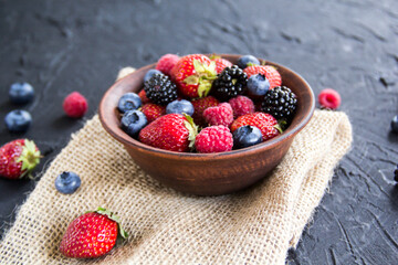 A healthy serving of fresh summer berries. Creative atmospheric decoration