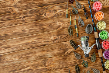 Accessories for carp fishing and fishing baits on wooden planks with copy space