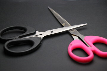 Dual colored scissors used for craft activities kept on black background