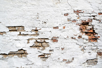 weathered brick wall with crumbling white plaster for background use
