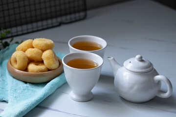 White ceramic tea set with donuts