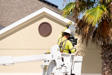 Man in a Lift Bucket, Replacing a Street Light in a Florida Neighborhood
