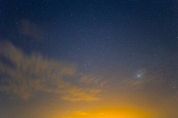 Fototapeta na wymiar night starry sky with clouds, natural sky background