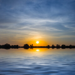Fototapeta na wymiar dramatic sunset reflected in a water, summer natural evening background