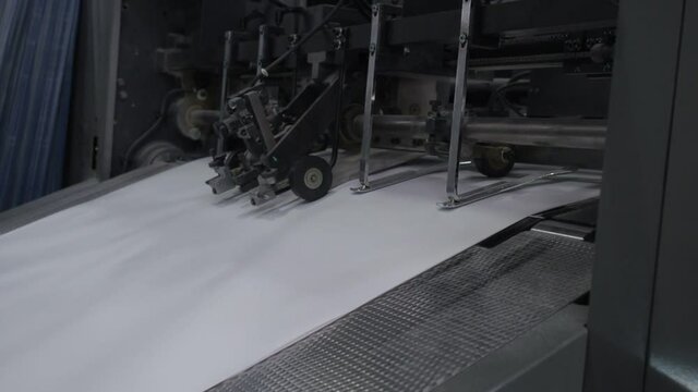 Printing offset machine paper feeder. Printing house.