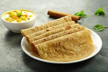 Healthy vegetarian meal- Indian flat bread chapati served with potato curry.
