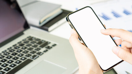 Businessman holding a white screen mobile work phone and typing an e-mail message