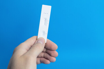 Coronavirus (COVID-19) rapid lateral flow test in hand. Rapid antigen test. COVID-19 Self-Test.