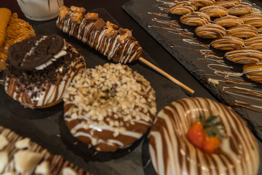 Assorted Donuts with Chocolate in Black Background 