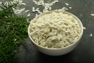 Organic rice flakes dry foods background.