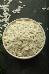 Flattened rice flakes , top view- Asian raw foods background.