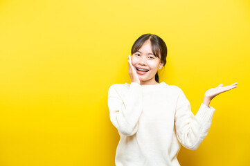 oung girl with headphones on yellow background