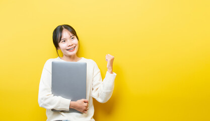 Full length body size turned photo of cheerful positive cute nice attractive blogger browsing through her laptop