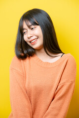 Photo of young attractive girl happy positive smile think hand touch chin isolated over yellow color background