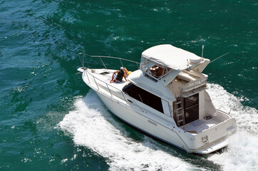 High-end cabin cruiser heading toward the open ocean.