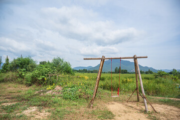 Fototapeta na wymiar traddition Wooden swing with beautiful mountian at chiang khan district loei thailand.
