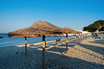Beach umbrellas from straw in the resort village of Nebug, Krasnodar Territory, Russia..