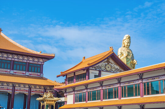 Guanyin goddress with temple rooftop and beautiful sky at foguangshan thaihua temple thailand.Fo Guang Shan is one of the four large Buddhist organizations in Taiwan