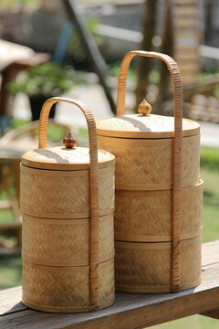 Two Tiffins Carrier On A Wooden Balcony.