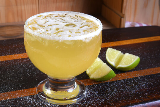 delicious and refreshing alcoholic drink with citrus fruits, margarita, cozumel on a table in a glass cup on the dark background