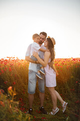 parent and child in red poppy field