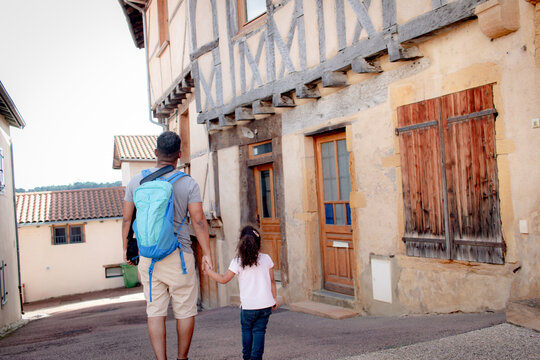 Girl with her vacation dad in the village of Perreux, France