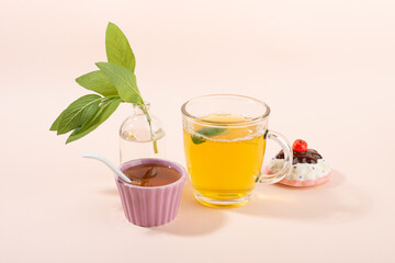 Cup of sage herbal tea, fresh sage leaves, honey and lemon.