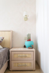 The interior of bedroom. The nightstand with home decor.