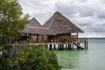 Fototapeta na wymiar landscape of an island in the sea with trees, thatched roof buildings and resting places 