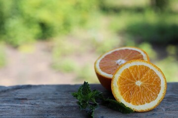 sliced orange on blurred green background