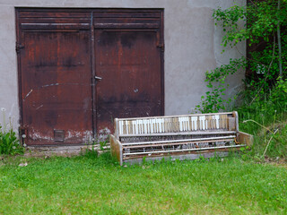 Old piano discarded on the ground as trash. Shot in Sweden, Scandinavia