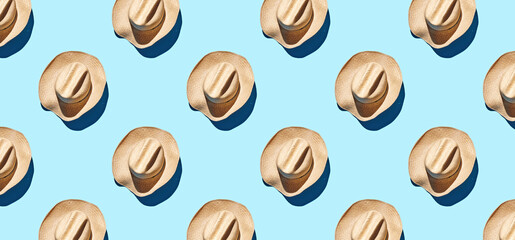Pattern of straw hats on blue pastel background
