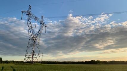 Metal poles electric supports for high-voltage wires in the fields in the summer.High Voltage Poles or Electric tower is transmission high voltage power locate on green field Energy technology concept