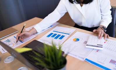 Business Financial and tax systems concept. Close up Businesswoman or Accounting calculating...