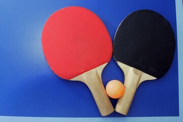 ping pong paddle with orange ball