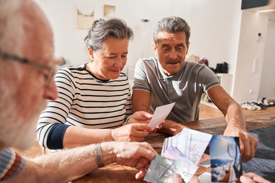 People watching photos and remembering funny memories from their life