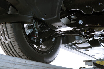Modern car in a car service on a lift. Bottom view of the front suspension of the car. Selected...
