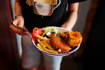 person eating chips and fries in restaurant