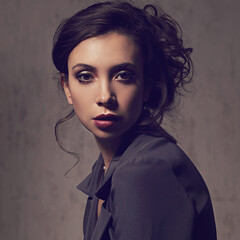 Beautiful bright amzing face makeup woman posing with burgundy lipstick and vamp look in grey...