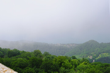 View of mountains and forest from above, mountain Akhun hills and forest in the morning fog