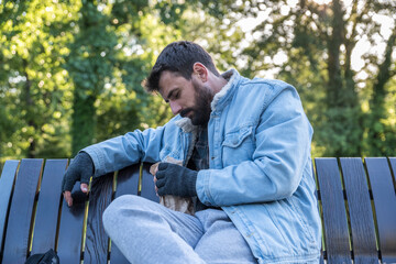 Young sick mentally ill tired poor dirty drunk alcoholic homeless man or refugee sleeping on the...