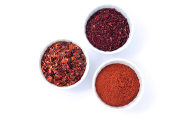 Bowls red spices chilli pepper powder dried tomatoes isolated on white background