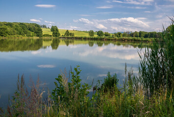 Landscape with a summer lake and reflections in the water