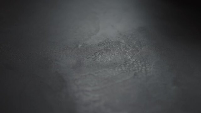 Slow motion handheld shot of gray concrete surface