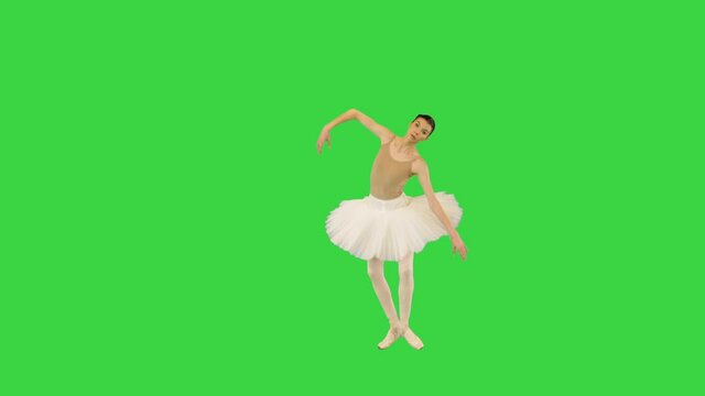 Young ballerina performing some ballet movements on a Green Screen, Chroma Key.