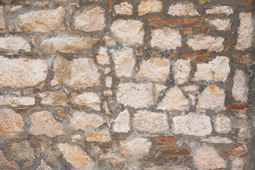 old stone wall with irregular blocks