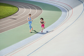 Fototapeta na wymiar Midget woman running on the stadium with her best friend