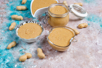 Homemade peanut butter in a jar and bowl.