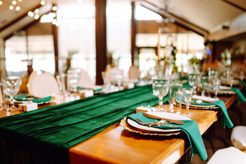 Wedding. Banquet. Beautiful table setting for a party, wedding reception or other festive event emerald colour.